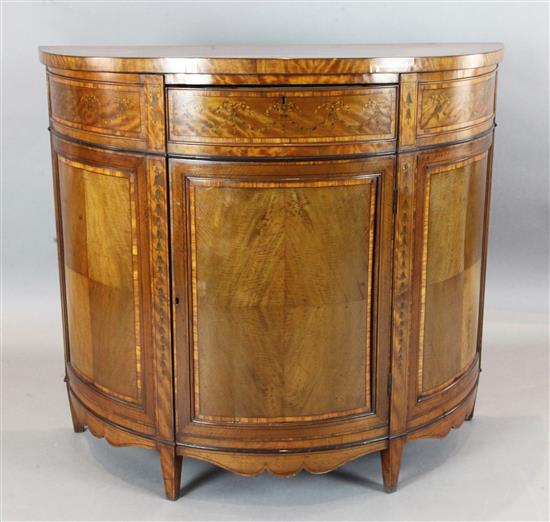 An Edwardian Edwards & Roberts marquetry inlaid satinwood demi-lune side cabinet, W.3ft 10in. D.1ft 8in. H.3ft 4in.